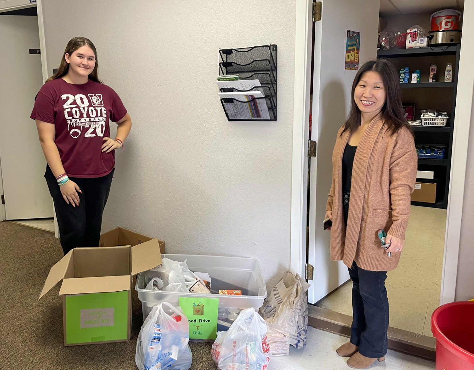 Donations to the Food Pantry are pictured with Food Pantry Staff and Kim Knape from Uvalde School of Gymnastics.