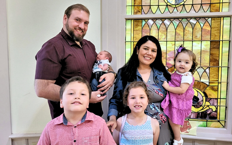 GED graduate Eunice Garza poses with her husband at kids.