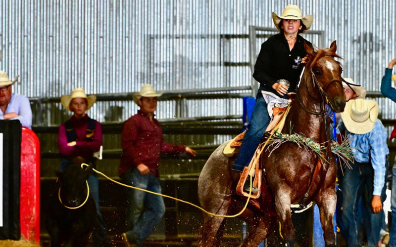 Rodeo athlete rides a horse at the 62nd Annual Southwest Texas College Rodeo