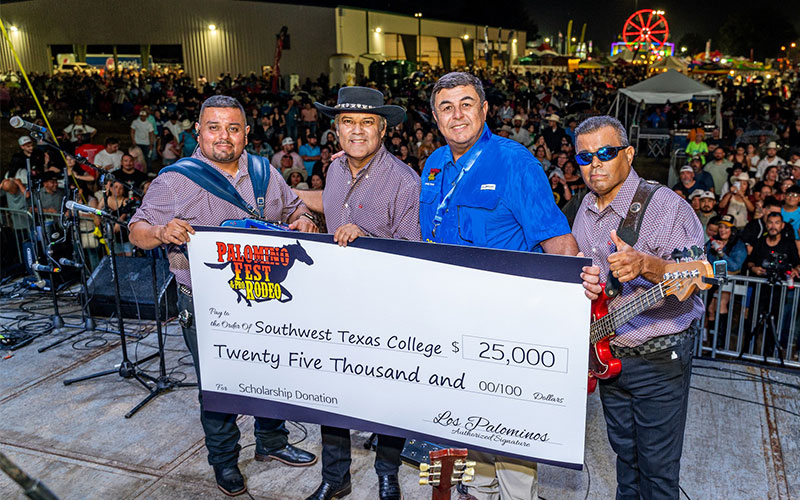 Photo of SWTX President Hector Gonzales with members of Los Palominos posing with a donation check for $25,000 to be used towards scholarships.